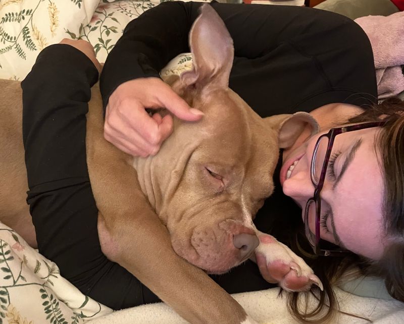 Cuddling with Sister's Dog