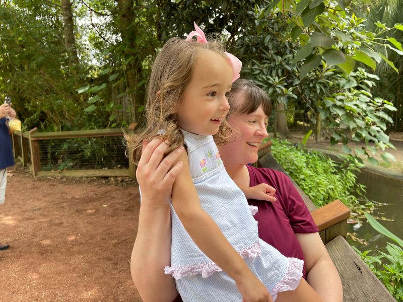 Melissa Helping Our Niece Get a Better View of the Flamingos at the Zoo